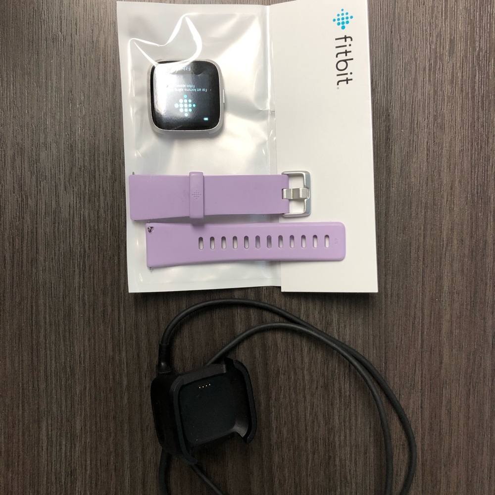 Brand new FitBit Versa Lite with lilac band